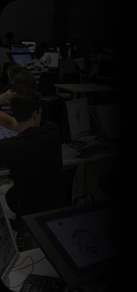 Students working at digital tablets and monitors in a production lab