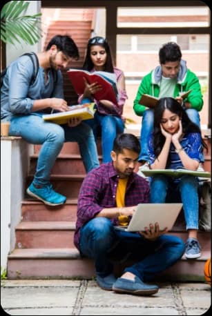 Students studying together on campus stairs