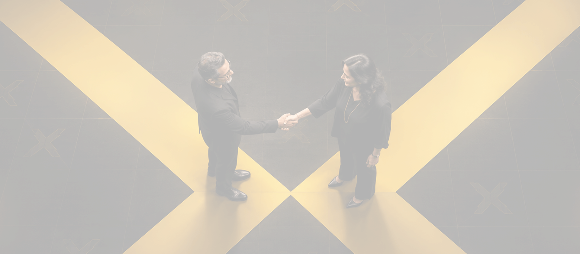 Industry professionals sealing a partnership handshake over Frameboxx branding